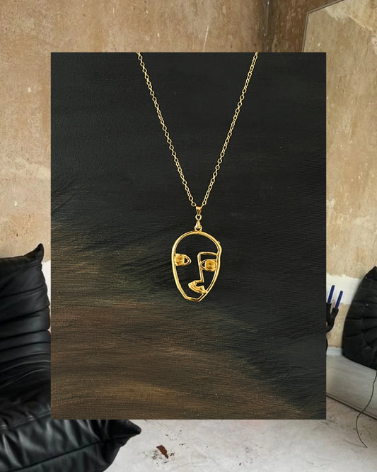 Golden face necklace