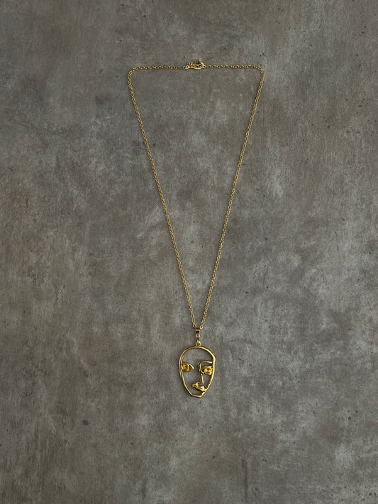 Golden face necklace